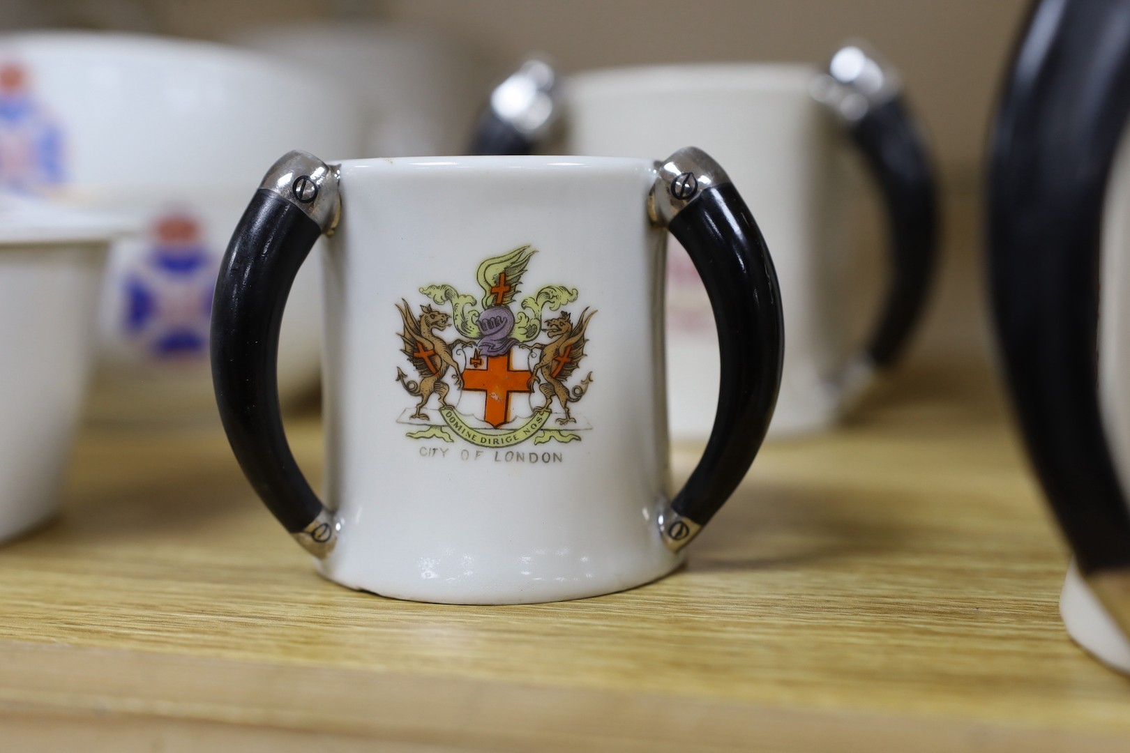 Society of Miniature Rifle Clubs - A large group of commemorative porcelain tea wares, three handled tygs and plates awarded for skill in rifle shooting, early 20th century